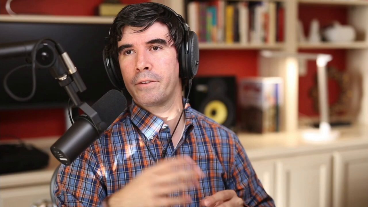 Armando J. Perez-Carreno in a blue plaid shirt talking into a microphone on episode 6 of The Web Talk Show