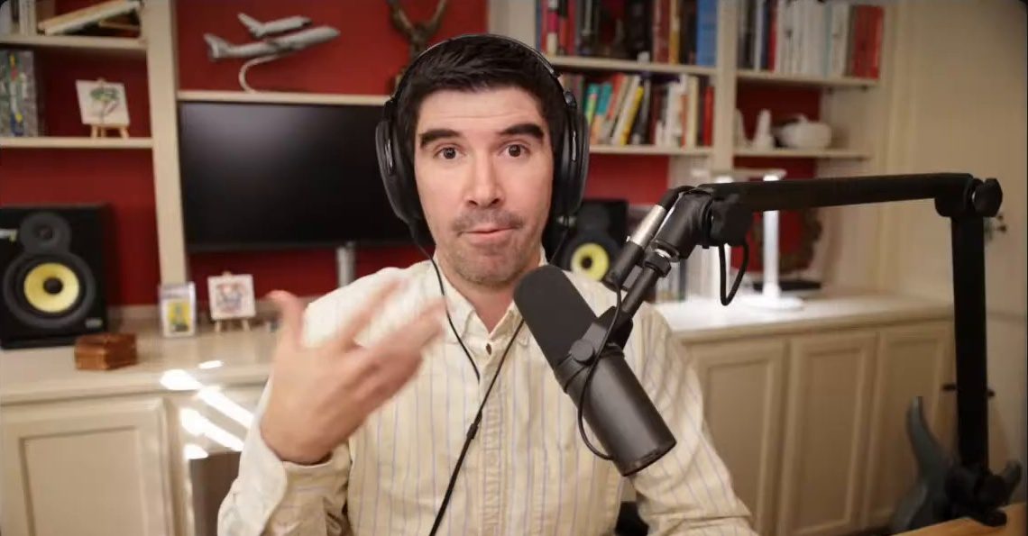 Armando J. Perez-Carreno in a cream striped shirt talking into a microphone on episode 31 of The Web Talk Show