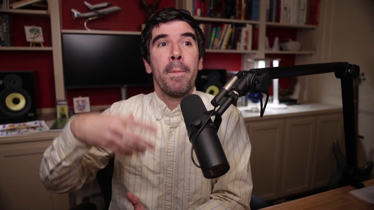 Armando J. Perez-Carreno in a cream shirt talking into a microphone on episode 51 of The Web Talk Show