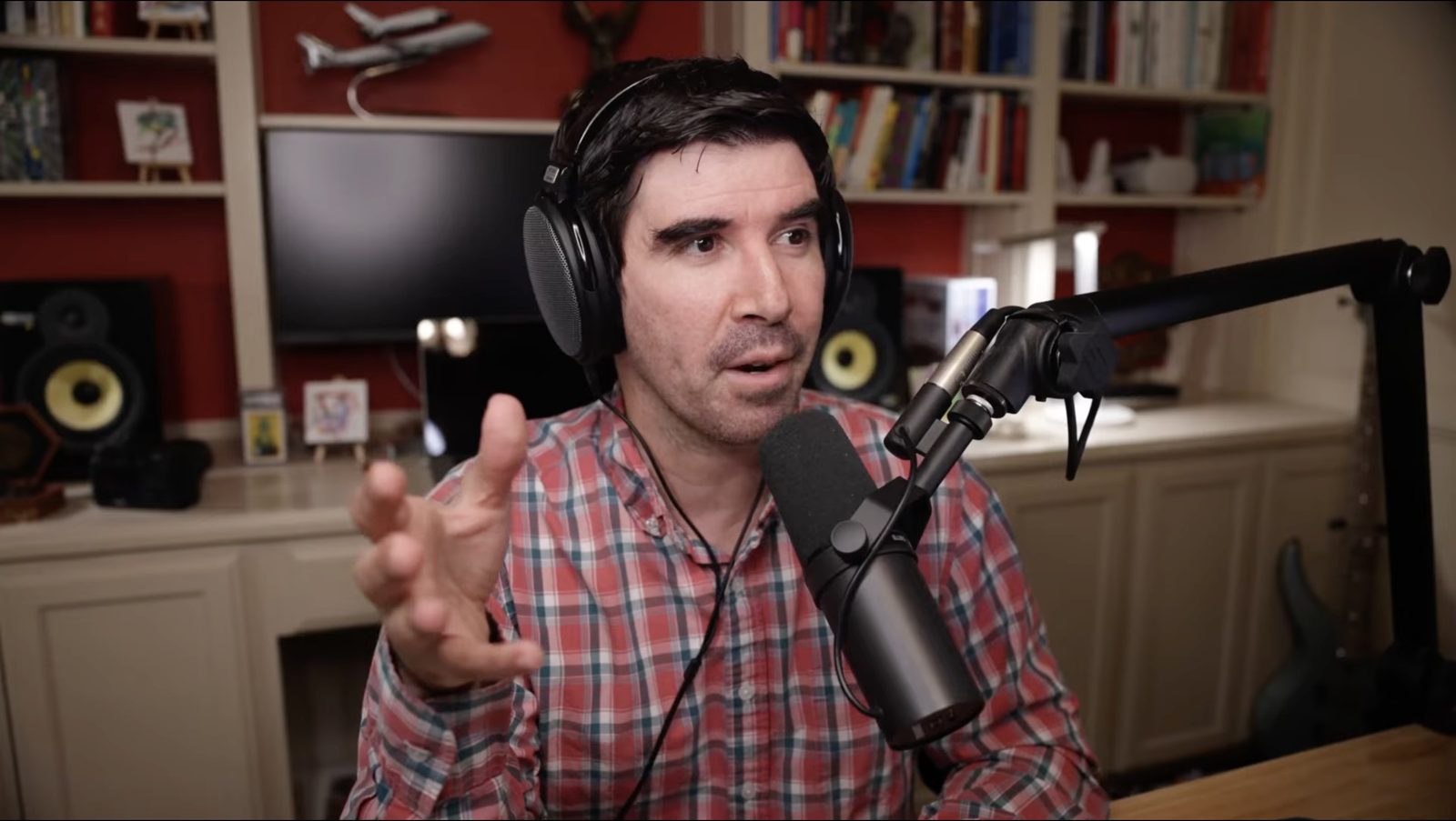 Armando J. Perez-Carreno wearing headphones and talking into a microphone while hosting The Web Talk Show