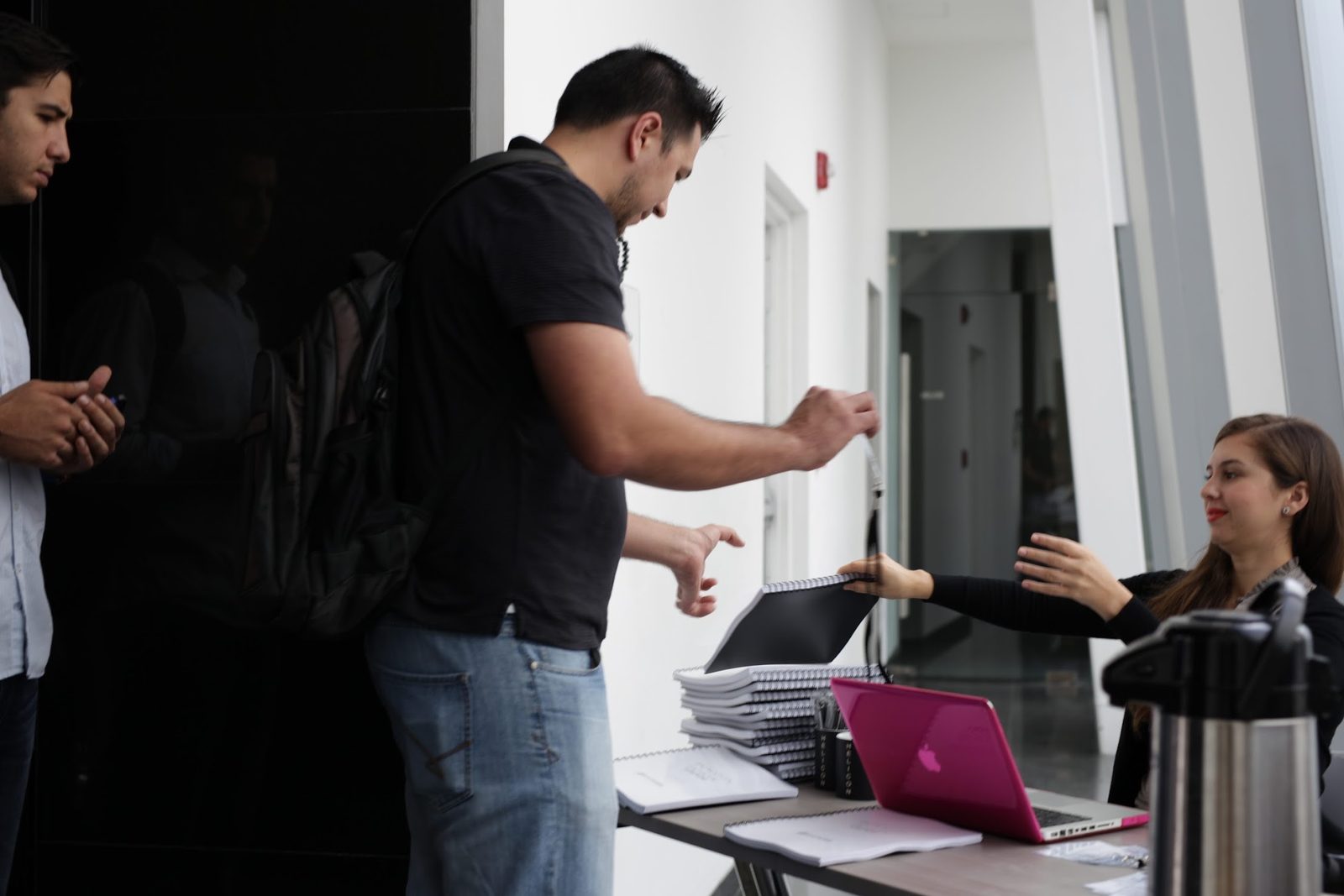 Attendees signing in and picking up workbooks at the start of a workshop led by Armando J. Perez-Carreno